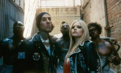 A Group Of People Standing Next To Each Other In An Alleyway GIF