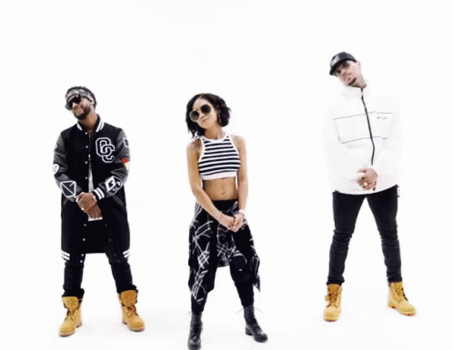 A Group Of People Standing Next To Each Other With One Wearing A Jacket With The Letter G On It GIF