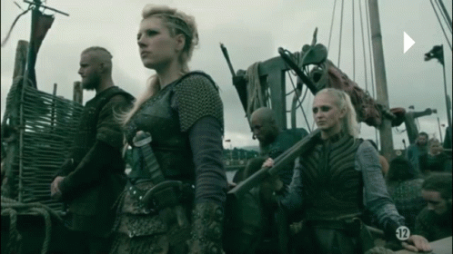 A Group Of People Standing Next To Each Other With The Number 12 On Their Sleeves GIF