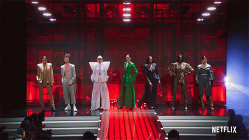 A Group Of People Standing On A Stage With Netflix Written On The Bottom GIF