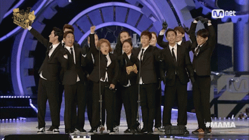 A Group Of People Standing On A Stage With The Word Mama On The Bottom GIF