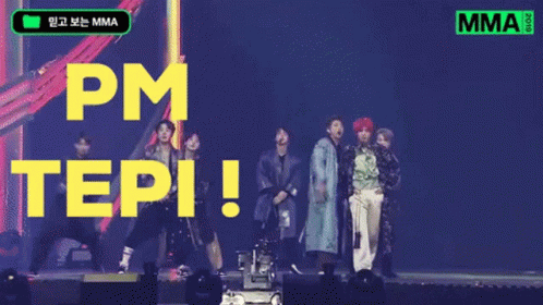 A Group Of People Standing On A Stage With The Words Pm Tepi Written In Yellow Letters GIF