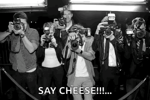 A Group Of People Taking Pictures With Cameras And The Caption Say Cheese GIF