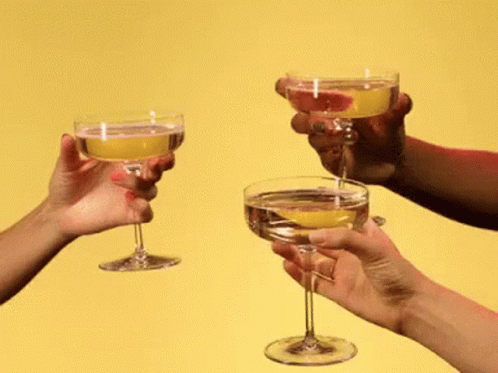 A Group Of People Toasting With Champagne Glasses GIF