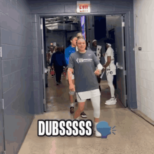 A Group Of People Walking Down A Hallway With The Word Dubssss On The Bottom GIF