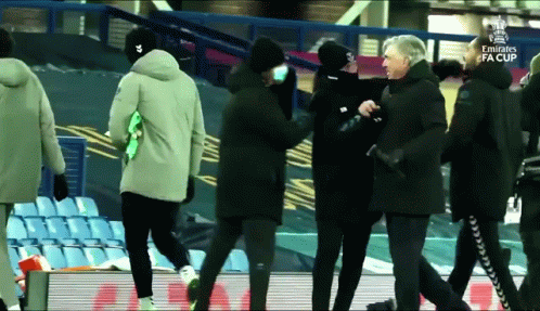 A Group Of People Walking On A Soccer Field With The Emirates Fa Cup Written On The Bottom GIF