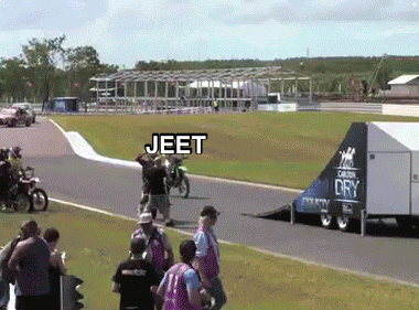 A Group Of People Watching A Motorcycle Race With Jeet Written On The Bottom Right GIF
