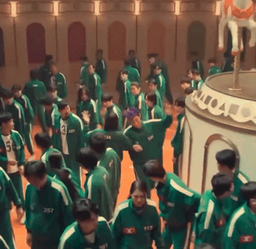A Group Of People Wearing Green Uniforms With Numbers On Them GIF