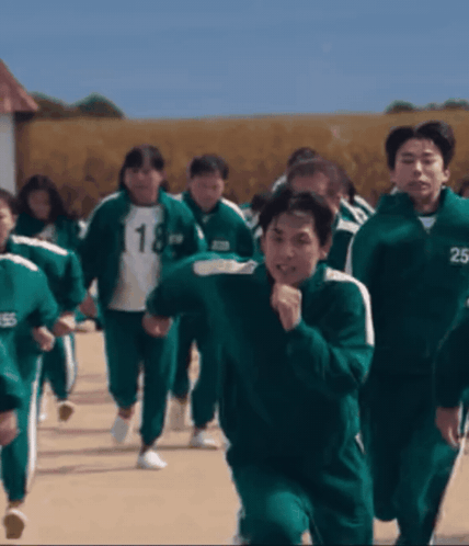 A Group Of People Wearing Green Uniforms With The Number 18 And 25 On Their Jackets GIF