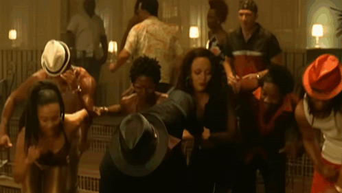 A Group Of People Wearing Hats Are Dancing GIF