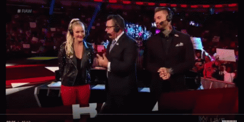 A Group Of People Wearing Headphones Are Standing In Front Of A Crowd On A Stage . GIF