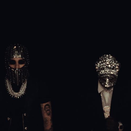 A Group Of People Wearing Masks Are Standing Around A Couch GIF