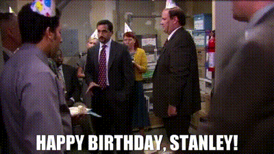 A Group Of People Wearing Party Hats Are Standing In A Room With The Words Happy Birthday Stanley . GIF