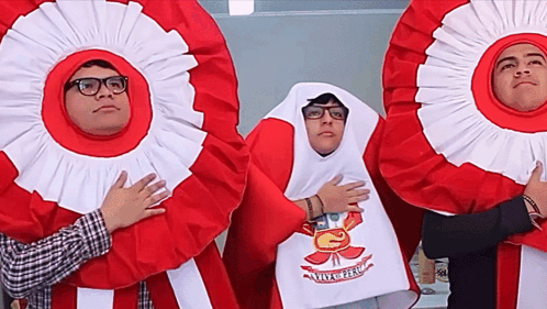 A Group Of People Wearing Red And White Ribbons With The Letter G On The Front GIF