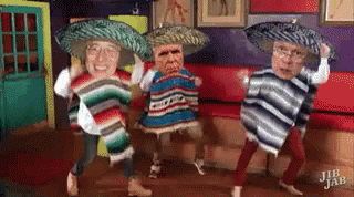 A Group Of People Wearing Sombrero 'S And Ponchos Are Dancing In A Room . GIF