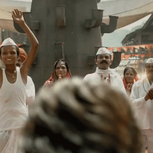 A Group Of People Wearing White Shirts And Hats Are Dancing GIF