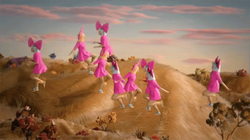 A Group Of Pink Dolls With Bows On Their Heads Are Dancing On Top Of A Hill GIF