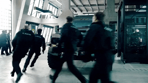 A Group Of Police Officers Are Running Towards A Vehicle That Says ' Lapd ' On It GIF