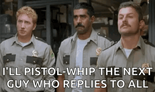 A Group Of Police Officers Are Standing Next To Each Other And One Of Them Is Holding A Gun . GIF