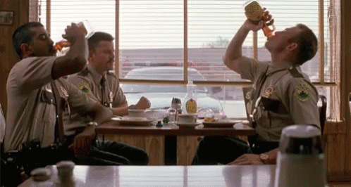a group of police officers drinking beer at a diner