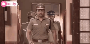 A Group Of Police Officers Walking Down A Hallway . GIF