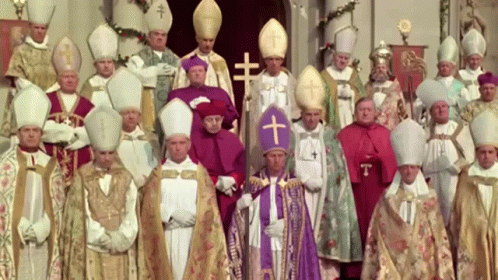 A Group Of Priests Are Posing For A Picture With A Cross On Their Hats GIF