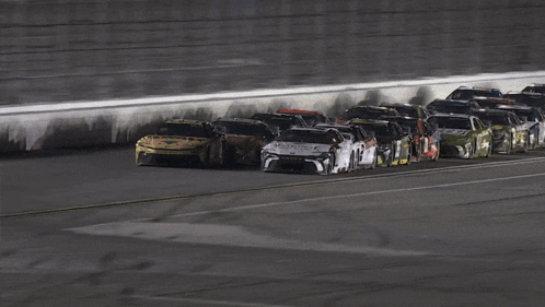 a group of race cars are lined up on a race track