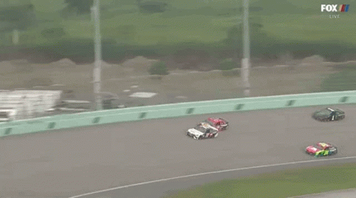 A Group Of Race Cars Are Racing On A Track With Fox Broadcasting GIF
