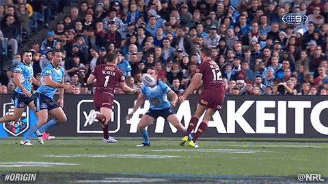 A Group Of Rugby Players Are Playing A Game Of Rugby In Front Of A Crowd . GIF