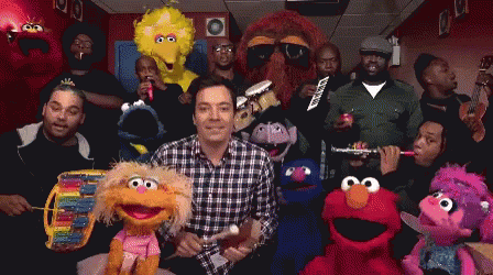 A Group Of Sesame Street Characters Are Posing For A Photo With Jimmy Fallon GIF
