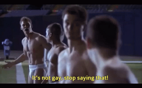 A Group Of Shirtless Men Are Standing On A Football Field And One Of Them Is Saying It 'S Not Gay , Stop Saying That GIF