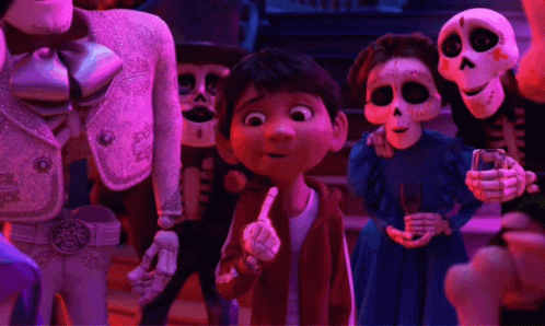 A Group Of Skeletons Are Standing Around A Young Boy Pointing GIF