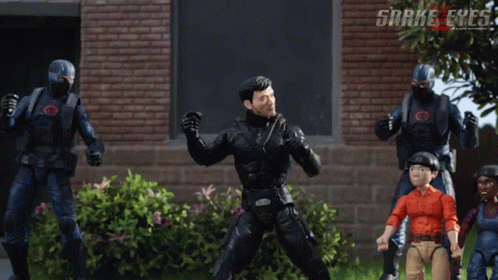 A Group Of Snake Eyes Action Figures Are Standing In Front Of A Brick Wall GIF