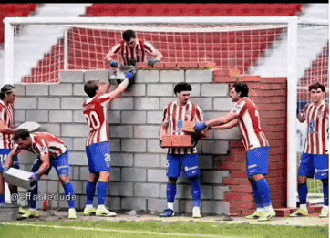 A Group Of Soccer Players Are Building A Wall GIF