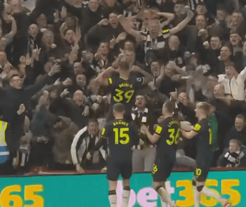 A Group Of Soccer Players Are Celebrating A Goal And One Of Them Has The Number 15 On His Back GIF