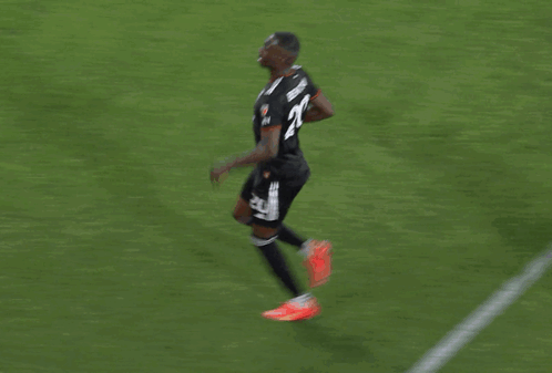 a group of soccer players are celebrating a goal and one of them has the number 23 on his back