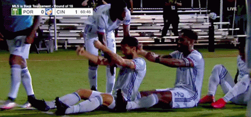 A Group Of Soccer Players Are Celebrating A Goal During A Game Between Por And Cin GIF