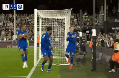 a group of soccer players are celebrating a goal with a score of 1-3
