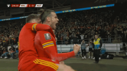 A Group Of Soccer Players Are Celebrating A Goal With The Score At 1-0 GIF