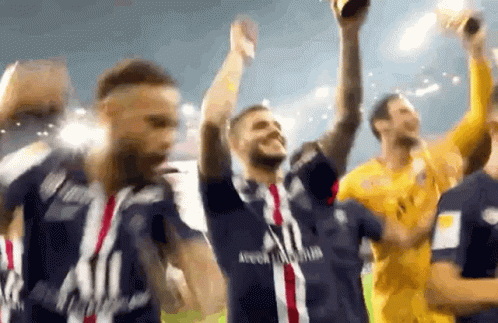 A Group Of Soccer Players Are Celebrating With A Trophy In Their Hands . GIF