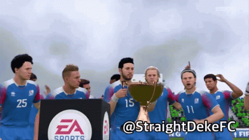 A Group Of Soccer Players Are Holding A Trophy In Front Of A Ea Sports Sign GIF