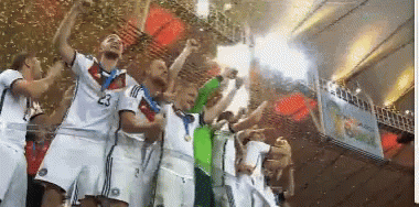 A Group Of Soccer Players Are Holding Up A Trophy And One Has The Number 23 On His Shirt GIF