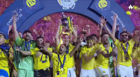 A Group Of Soccer Players Are Holding Up A Trophy Under A Sign That Says Champions GIF