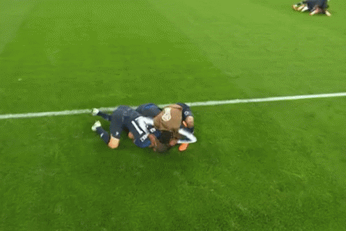 A Group Of Soccer Players Are Huddled Together On The Field And One Player Has The Number 15 On His Jersey GIF