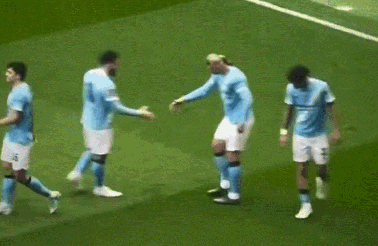 A Group Of Soccer Players Are Hugging Each Other On A Field GIF