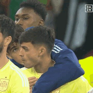 A Group Of Soccer Players Are Hugging Each Other With A Da Zn Logo In The Corner GIF