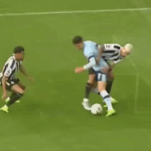 A Group Of Soccer Players Are Playing A Game Of Soccer On A Field . GIF