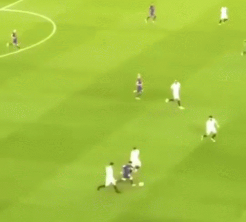 A Group Of Soccer Players Are Playing A Game On A Field . GIF