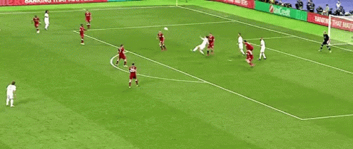 A Group Of Soccer Players Are Playing A Game On A Field With Advertisements On The Sidelines . GIF