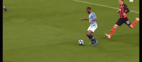 A Group Of Soccer Players Are Playing A Game On A Soccer Field . GIF